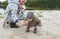 Happy mother and baby girl with her puppy making selfie outdoors