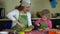 Happy mother baking with little daughter in apron. family girls in kitchen