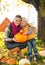 Happy mother and child holding pumpkin