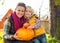 Happy mother and child holding pumpkin