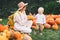 Happy mother and child at pumpkin patch outdoors