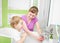 Happy mother and child washing hands with soap together