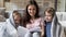 Happy mother with children covered with warm blanket reading book