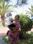 Happy mother with cute baby boy having tropical vacation on Maldives. Kid playing among palm trees