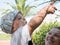 Happy mother with cute baby boy having tropical vacation on Maldives. Kid playing among palm trees