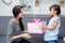 Happy of mother and daughter asian with gift with pink ribbon