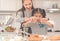 Happy Mother and Daughter is breaking egg to make Bakery in kitchen together, for family fun activity concept