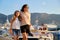 Happy mother and daughter child walking together holding hands along seafront