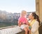 Happy mother and daughter eating ice cream near Ponte Vecchio