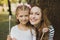 Happy mother and daughter eating sweet lollipops on holiday