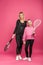 happy mother and daughter holding tennis rackets and ball, isolated