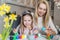 Happy mother and daughter painting easter eggs in the living room