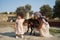 Happy mother and daughter playing with sheep outdoor