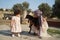 Happy mother and daughter playing with sheep outdoor