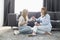 Happy mother and daughter talking while having coffee in living room