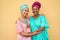 Happy mother and daughter with traditional african dresses smiling on camera - Family lifestyle and ethnic concept - Focus on