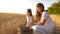 Happy mother farmer plays with little son, daughter in the field. mother and little child are playing with grain in a