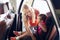 Happy mother fastening child with car seat belt