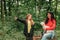 Happy mother and her daughter chatting, laughing and playing with dog outdoors