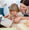 Happy mother and her daughter decorating a room