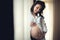 Happy mother holding hands on baby bump, pregnant belly. portrait of beautiful pregnant woman being happy