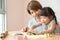 Happy mother and kid preparing the colorful dough.