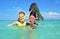 Happy mother and kid snorkeling in tropical sea