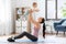 Happy mother with little baby exercising at home