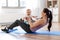 Happy mother with little baby exercising at home