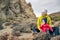 Happy mother with little boy travelling in mountains