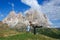 Happy mother with little daughter jumping at mountains Dolomites, Italy