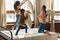 Happy mother playing pillow fight with two little daughters