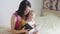 Happy mother reading a book to child boy indoors. Sweet moment with mother reading book to baby.