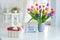 Happy Mother`s Day background. Colorful spring flowers bouquet in vase, gift box with satin ribbon and lightbox with words Best