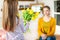 Happy Mother`s Day or Birthday Background. Adorable young girl surprising her mom with bouquet of yellow tulips.