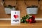 Happy Mother`s Day or Birthday Background. Homemade greeting card and bouquet of red roses on kitchen counter.