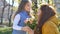 Happy mother`s day. Child daughter congratulates mom and gives her a flowers. Mum and girl smiling and hugging. Family