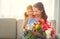 Happy mother`s day! child daughter gives mother a bouquet of f