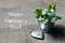 Happy Mother`s Day.Forget-me-not flowers in small metal bucket and vintage silver heart on old wooden table.