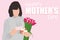 Happy Mother`s day greeting card. Woman holding greeting card, tulips and gift box on pink background and Happy Mothers day text.