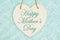 Happy Mother`s Day message on wood heart shaped plaque with teal plush fabric