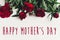 Happy mother`s day text sign on beautiful red peonies on white w