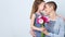Happy Mother`s Day, Women`s day or Birthday background. Cute little girl giving mom bouquet of pink gerbera daisies. Loving mother