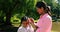 Happy mother standing with her daughter in park