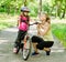 Happy mother talking with her â€‹â€‹daughter smiling, which teaching biking