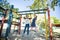 Happy mother talking to daughter hanging on jungle gym