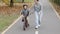 Happy Mother teaches child son to ride a bike on the bike path