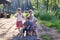 Happy mother with three little barefoot children pose