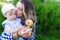 Happy mother and toddler daughter with mushroom outdoor portrait