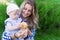 Happy mother and toddler daughter with mushroom outdoor portrait